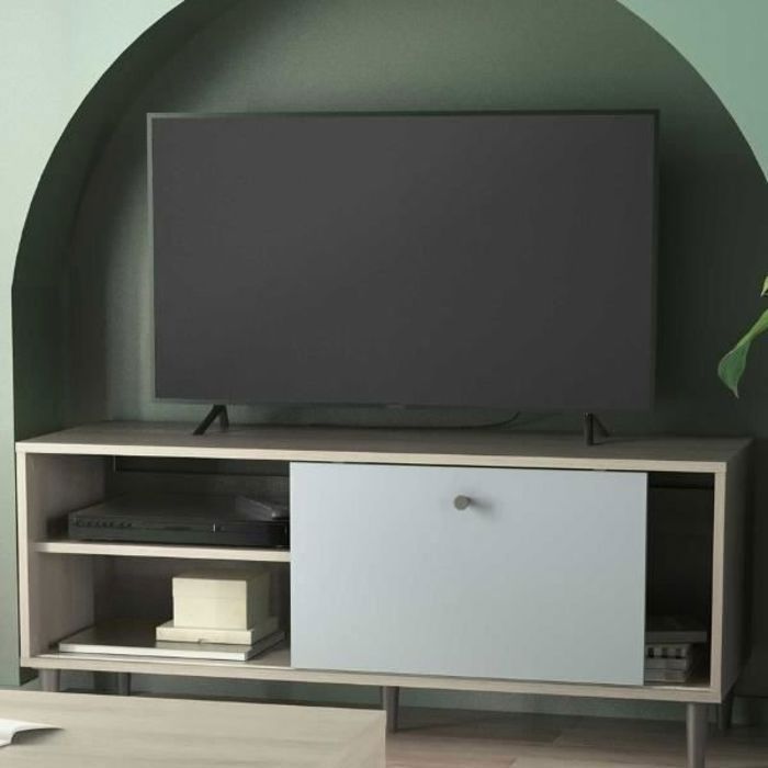 Meuble TV Aïda est fabriqué en panneaux de particules mélaminés en vert de gris avec décor chêne Kronberg et a des pieds noirs en...